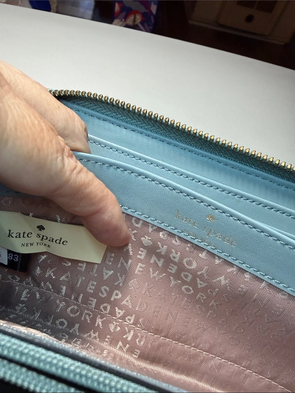 kate spade light blue pebbled gold tone zip-around wallet